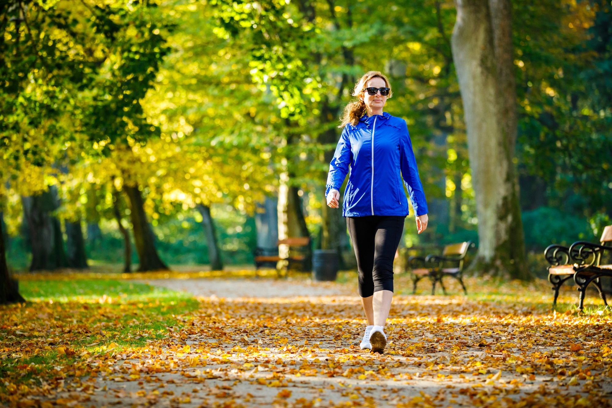 Middle-aged woman walking in city park