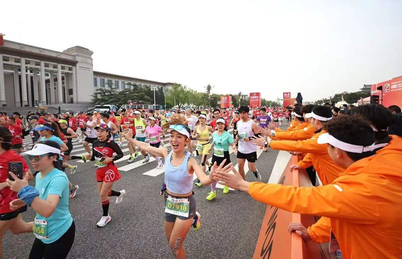 工作人员与参赛选手击掌互动。