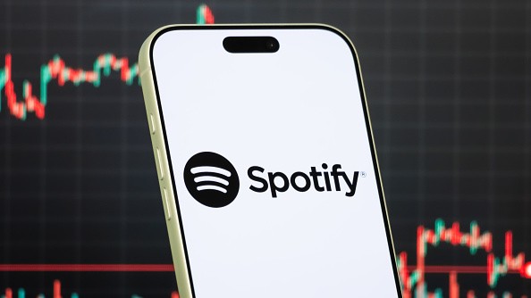 a smartphone displays the logo of Spotify
