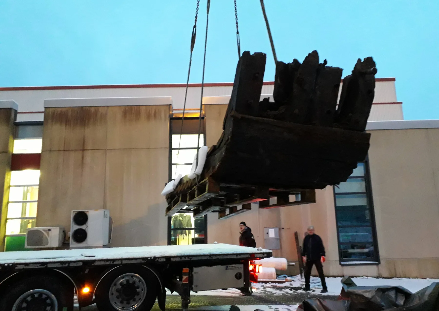 a piece of wood being lifted into a lab
