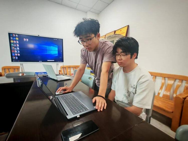 图 2 团队成员进行数据分析与平台调试